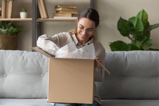 woman smiling and looking at a package