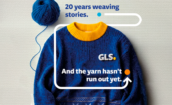 Blue knitted sweater with a yellow collar and GLS logo, accompanied by a ball of yarn and a corporate message celebrating 20 years of storytelling and brand heritage