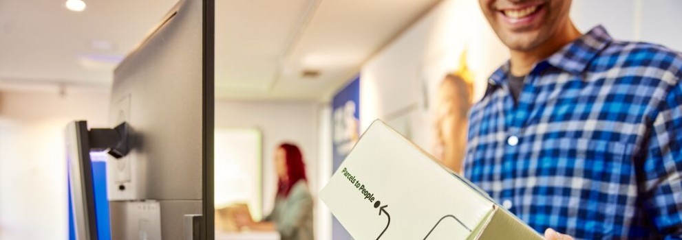 GLS business customer stands with folded arms in a store