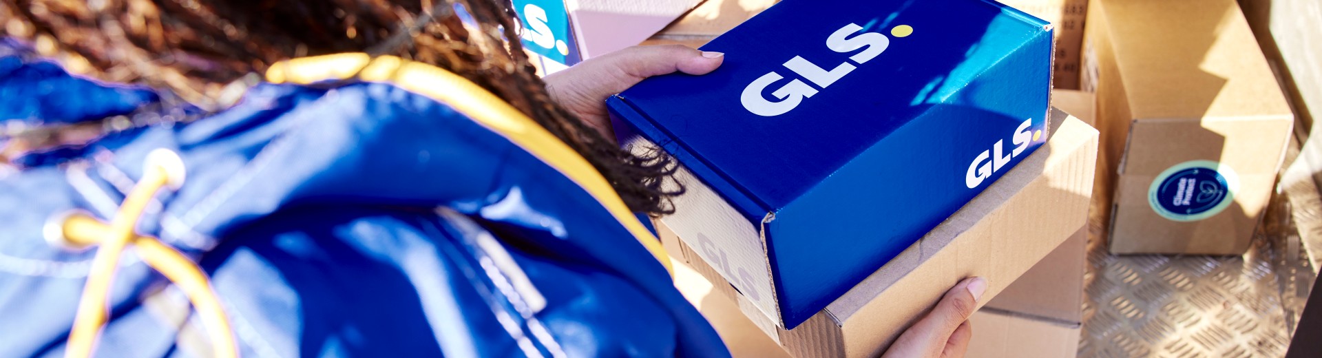 GLS employee takes a parcel out of the van