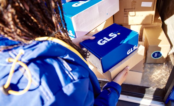 GLS employee takes a parcel out of the van