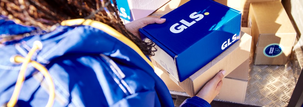 GLS employee takes a parcel out of the van