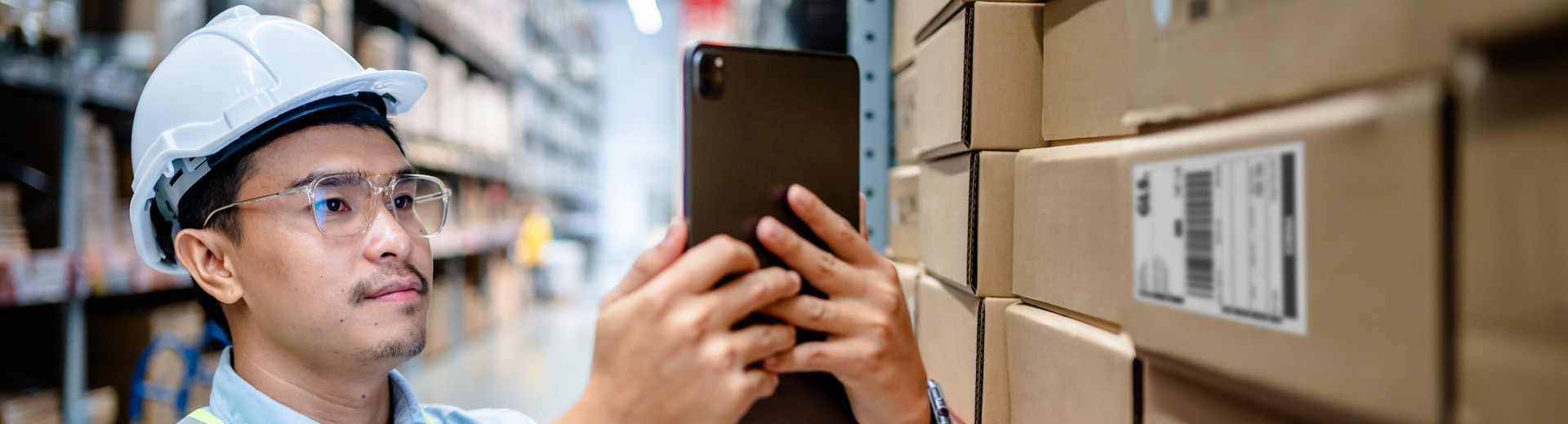 Man looking at his phone in a warehouse